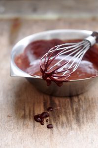 Melted chocolate in a metal bowl, dripping